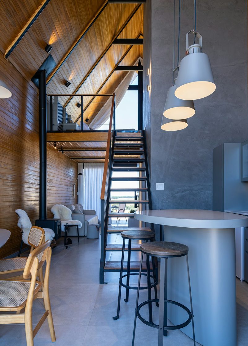 Modern vacation rental cabin interior with loft and stylish furnishings—the kind of property that benefits from professional management